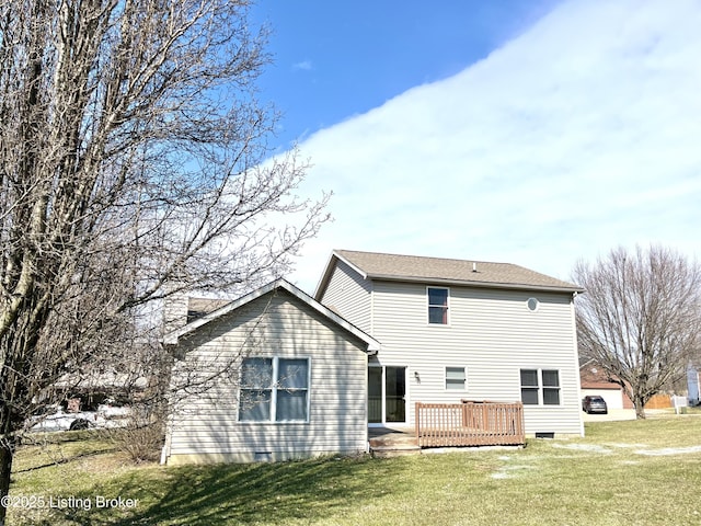 rear view of house with a wooden deck and a yard