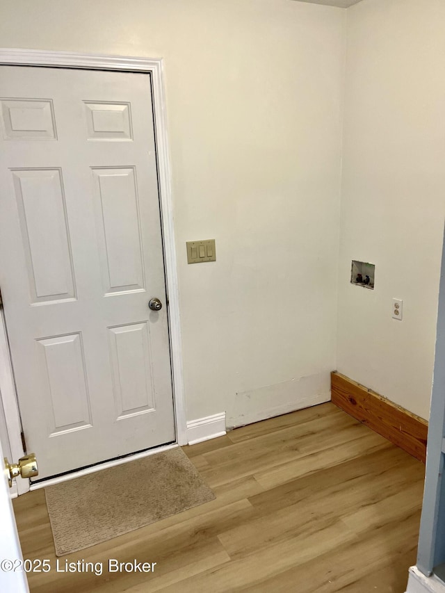 laundry room with baseboards, light wood-style floors, hookup for a washing machine, and laundry area