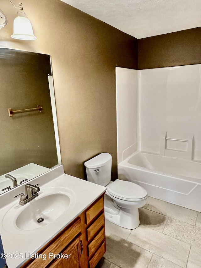 bathroom featuring vanity, bathing tub / shower combination, and toilet