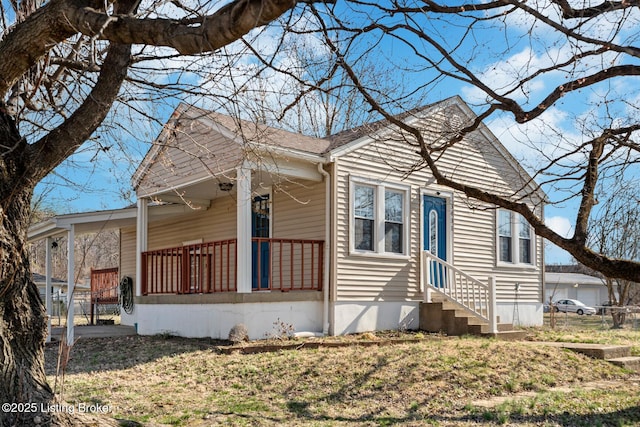 bungalow-style house with a porch, entry steps, and fence