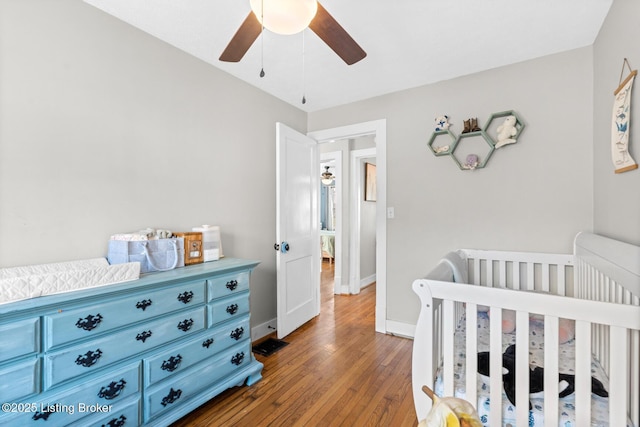 bedroom featuring baseboards, wood-type flooring, and ceiling fan