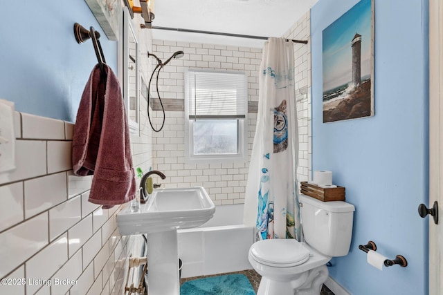 bathroom featuring tile walls, toilet, and shower / bath combo with shower curtain