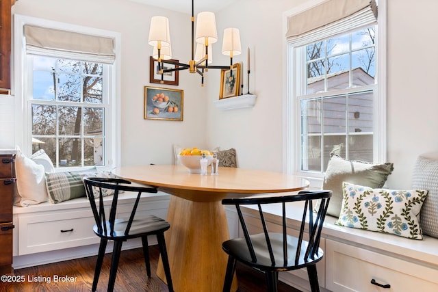 dining space with plenty of natural light, dark wood-style floors, a chandelier, and breakfast area