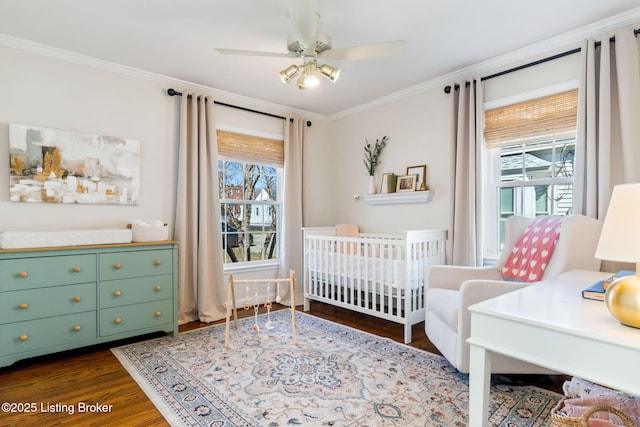 bedroom featuring multiple windows, dark wood-type flooring, and ornamental molding