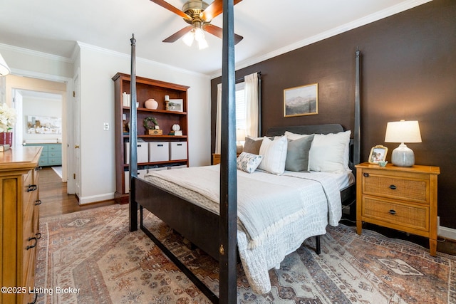 bedroom with ceiling fan, baseboards, wood finished floors, and ornamental molding