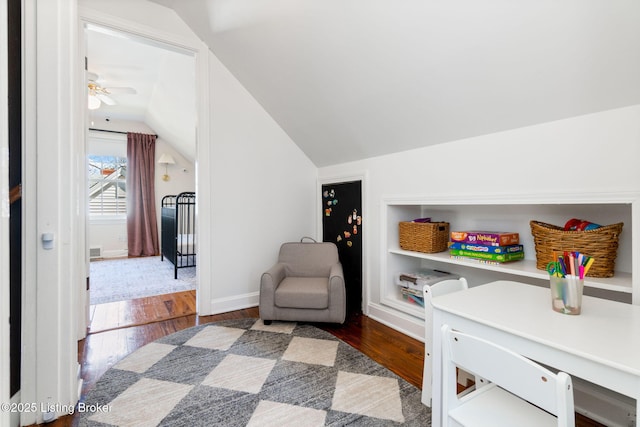 interior space with lofted ceiling, dark wood-style floors, and baseboards