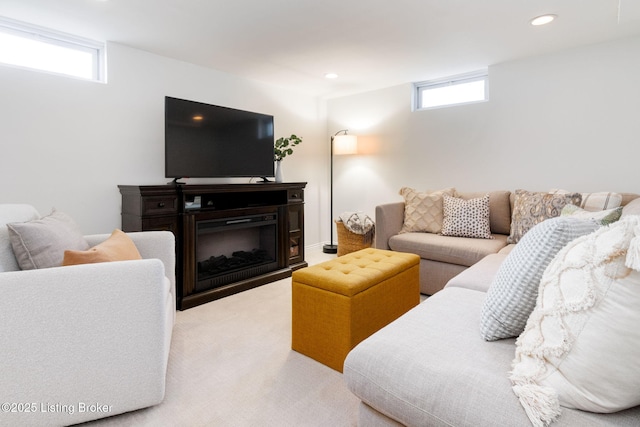 living area with recessed lighting, carpet, and a fireplace