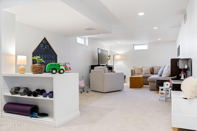 living area with recessed lighting, visible vents, and carpet