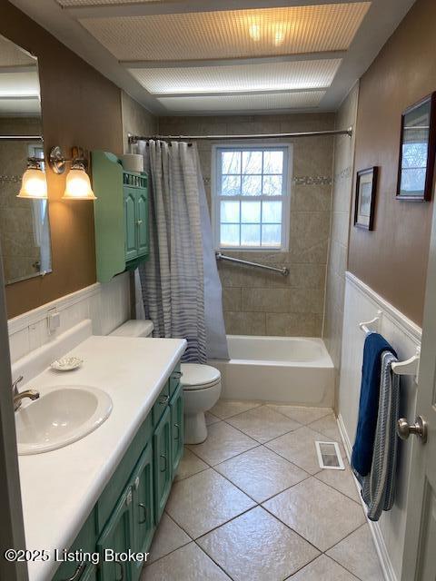 bathroom featuring tile patterned floors, visible vents, toilet, shower / tub combo, and vanity