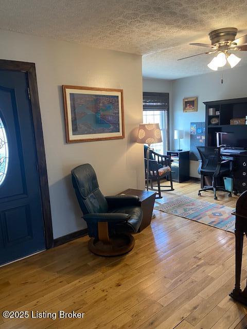 entryway with hardwood / wood-style floors, a ceiling fan, baseboards, and a textured ceiling