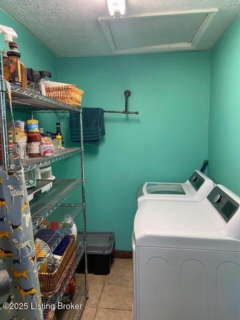 washroom featuring light tile patterned floors, laundry area, attic access, and separate washer and dryer