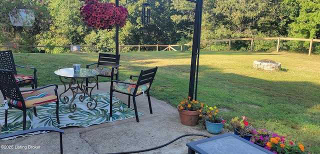 view of patio featuring fence and an outdoor fire pit