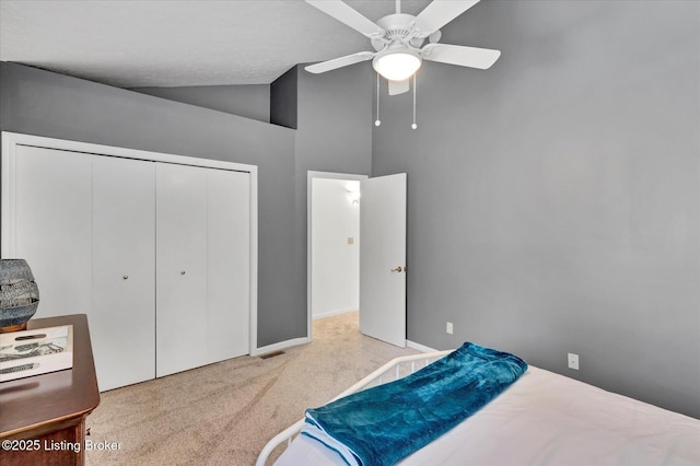 bedroom with vaulted ceiling, a ceiling fan, a closet, and carpet floors