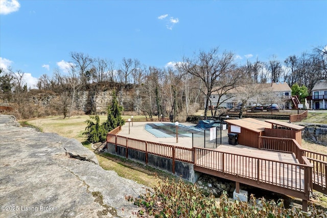 exterior space with a fenced in pool and a deck