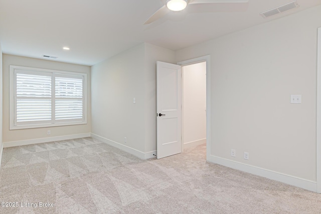 spare room featuring visible vents, baseboards, carpet, and a ceiling fan