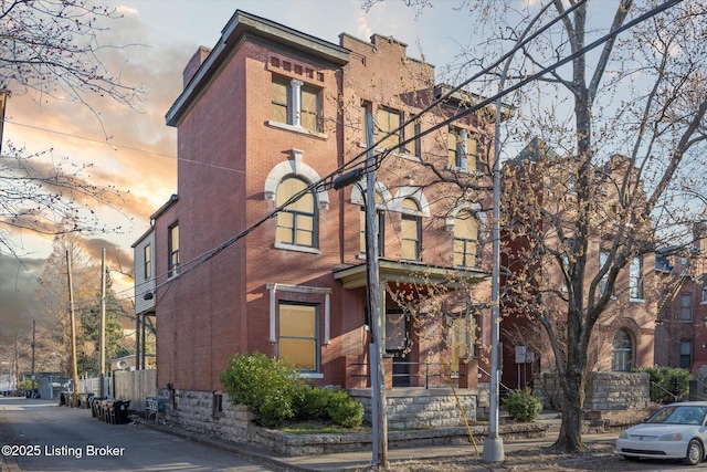 exterior space with fence and brick siding