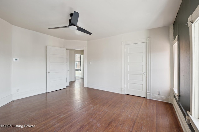 unfurnished bedroom featuring a ceiling fan, wood finished floors, and baseboards