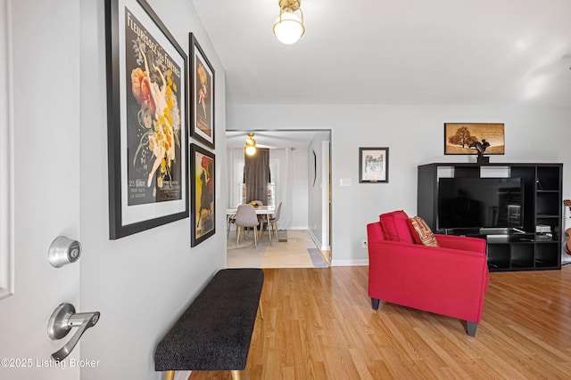 living room with baseboards and wood finished floors