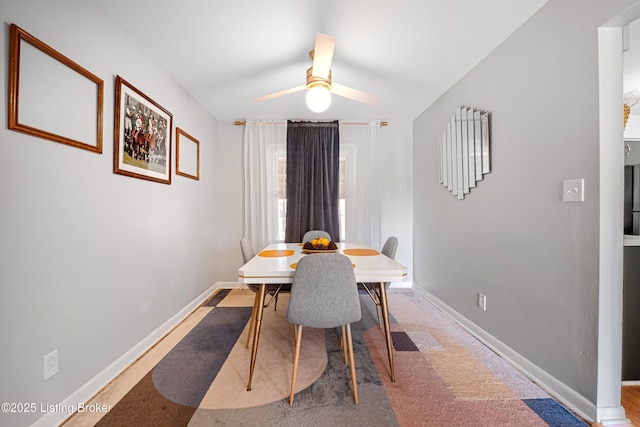 dining room with ceiling fan and baseboards