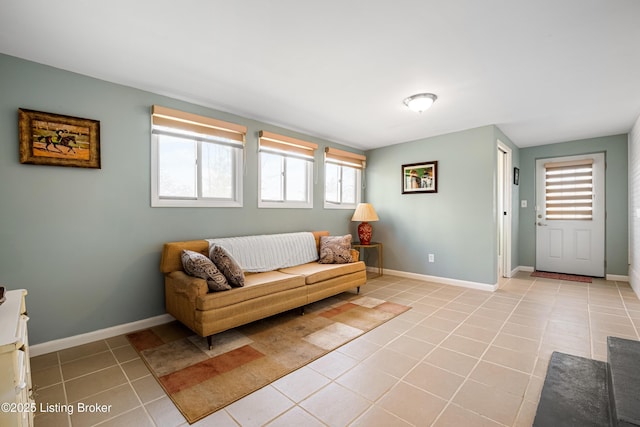 tiled living area featuring plenty of natural light and baseboards