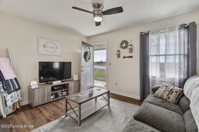 living area with a healthy amount of sunlight, a textured ceiling, and wood finished floors