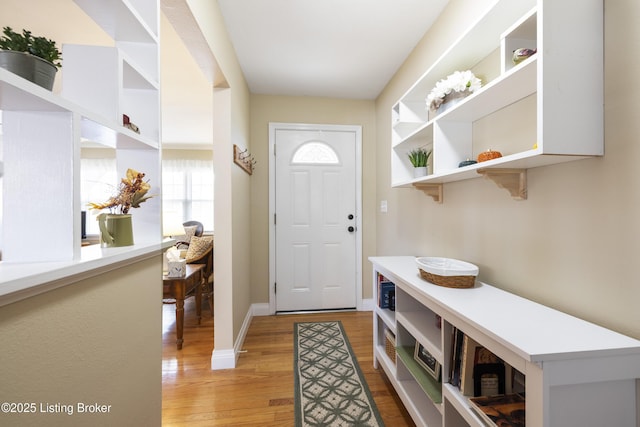 foyer featuring baseboards and light wood-style floors