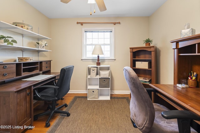 office space with wood finished floors, a ceiling fan, and baseboards