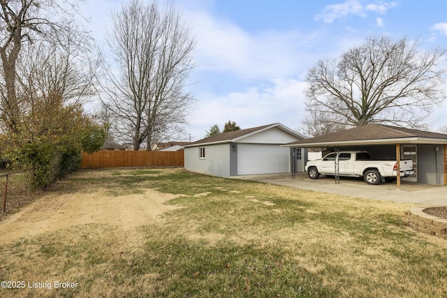 exterior space featuring a carport, an outdoor structure, a lawn, and fence