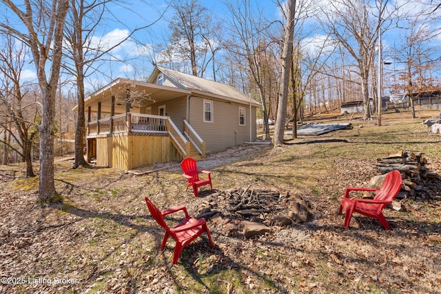 exterior space with a ceiling fan, stairway, and a fire pit