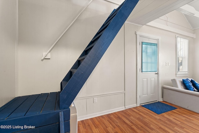 bonus room featuring lofted ceiling, wood finished floors, and stairs