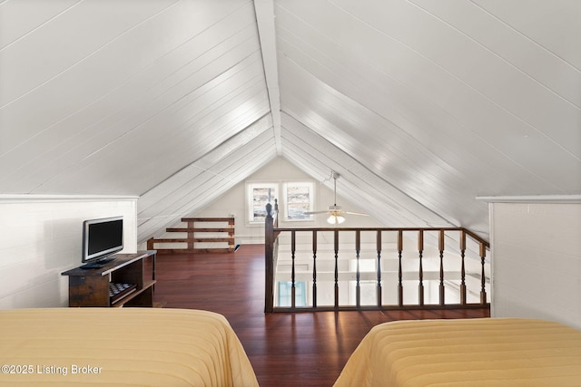 bedroom with lofted ceiling and wood finished floors