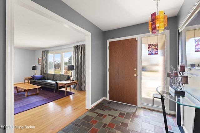 entrance foyer featuring baseboards and wood finished floors