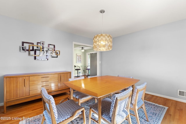 dining room with visible vents, baseboards, and light wood-style floors