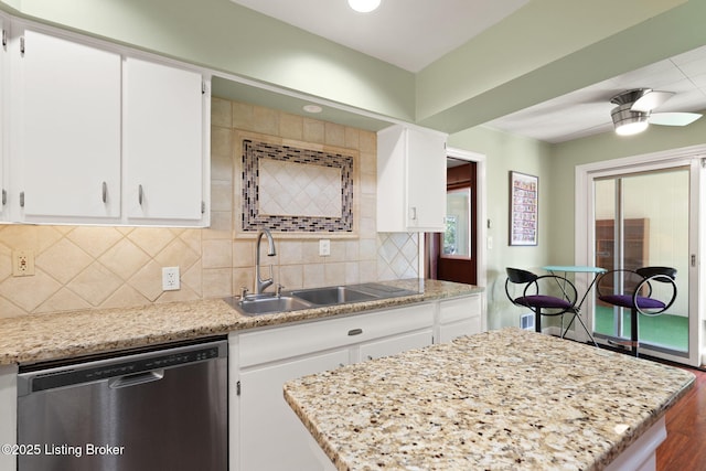 kitchen with a sink, white cabinets, decorative backsplash, dishwasher, and ceiling fan