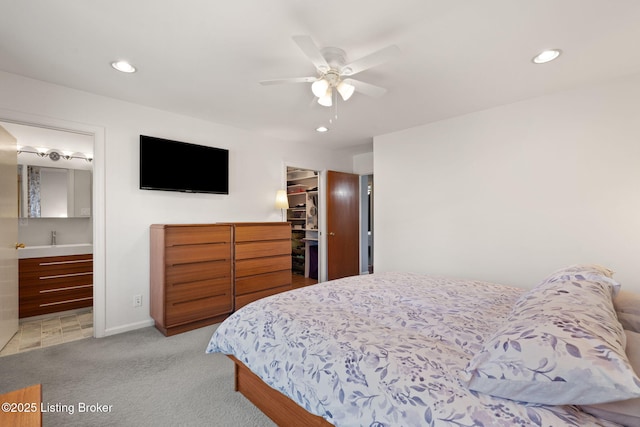 bedroom featuring a spacious closet, light colored carpet, recessed lighting, a closet, and a ceiling fan