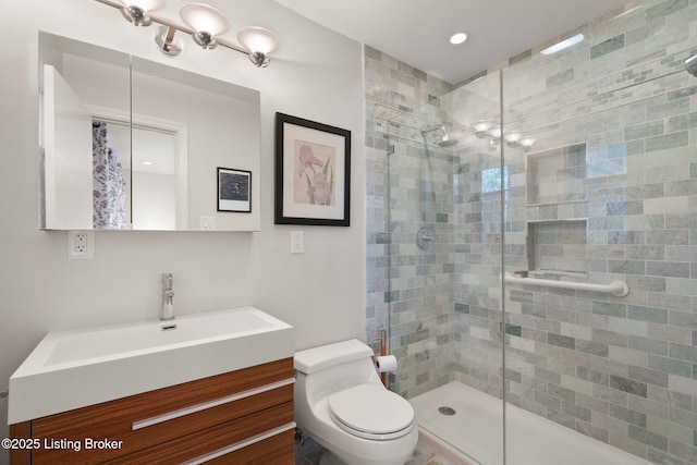 bathroom featuring a stall shower, toilet, and vanity