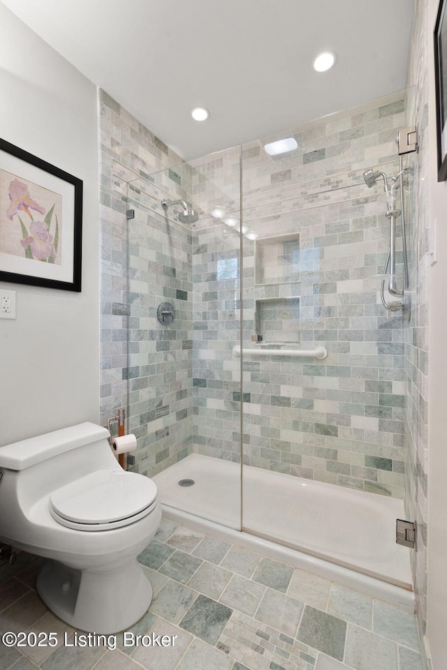 bathroom with recessed lighting, a stall shower, and toilet