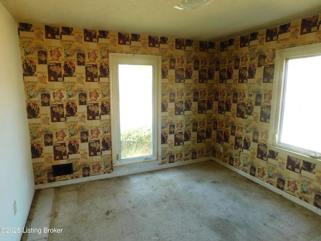 unfurnished room featuring baseboards, carpet, and wallpapered walls