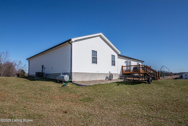 view of home's exterior featuring a lawn, heating fuel, and a deck