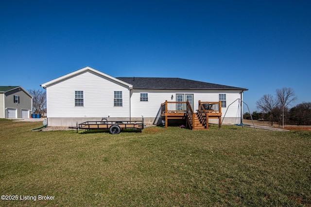 back of property featuring a lawn and a wooden deck