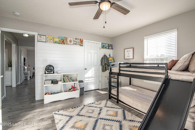 bedroom with ceiling fan, a closet, and wood finished floors