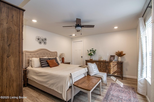 bedroom with recessed lighting, light wood-style flooring, a ceiling fan, and baseboards