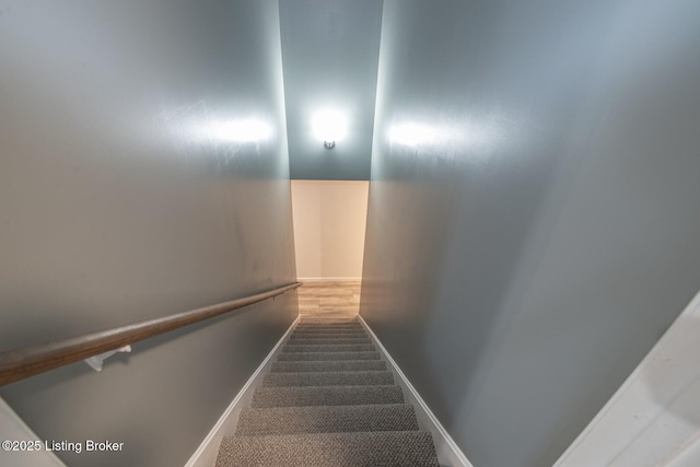 stairway with carpet and baseboards