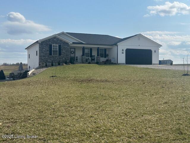 ranch-style house featuring a garage, stone siding, gravel driveway, and a front lawn