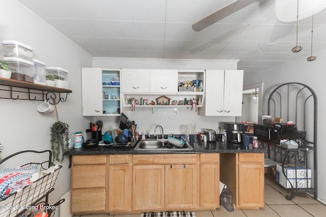 kitchen featuring open shelves, light tile patterned flooring, a ceiling fan, and a sink