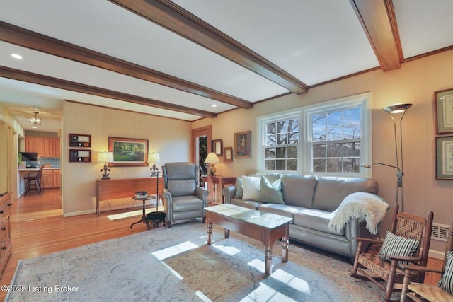 living area featuring beamed ceiling and light wood-style floors