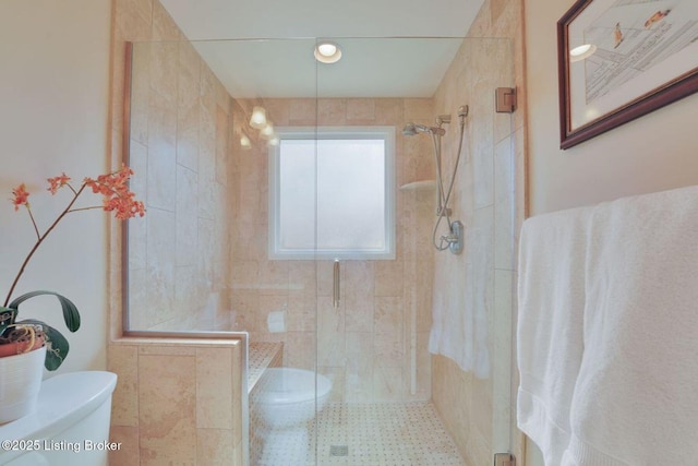 bathroom with toilet and a tile shower