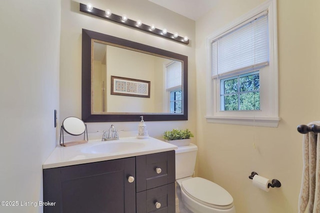 bathroom with toilet and vanity