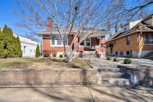 view of front of home with brick siding and a chimney