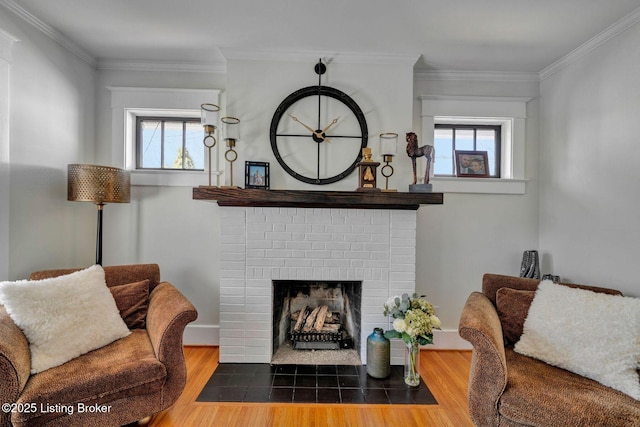 living area with crown molding, plenty of natural light, and wood finished floors